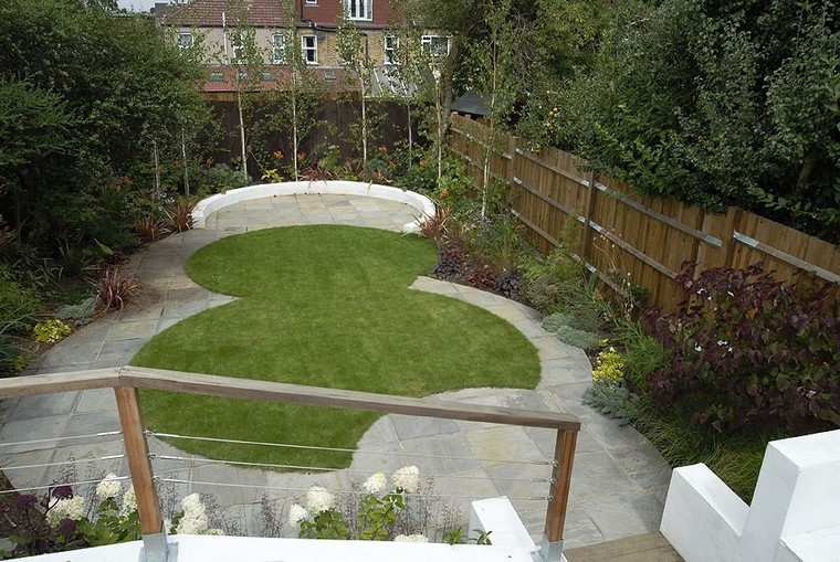 A Beautiful Circular Garden with Grass, Flowers, and Curved Stairs