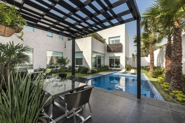 jardín con piscina y pérgola metálica pergola metal jardin piscina palmeras