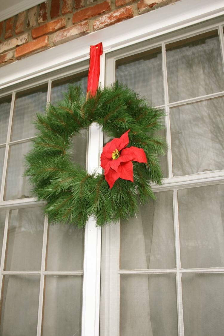 ramas de pino adornos navideños ventanas exteriores ladrillos
