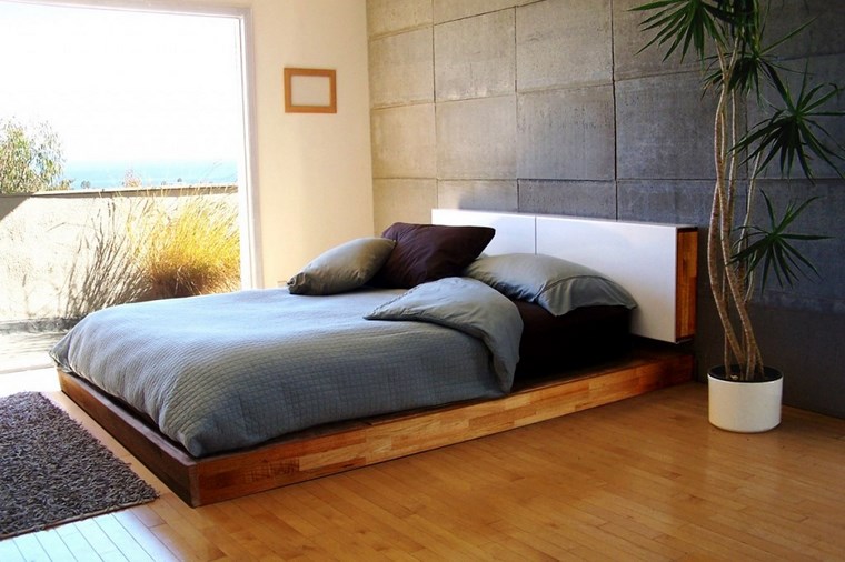 cama de madera y pared de hormigón pared hormigon expuesto salon diseno minimalista ideas