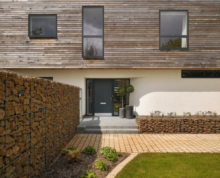 casa moderna con muros de piedras gavion piedras color marron moderno