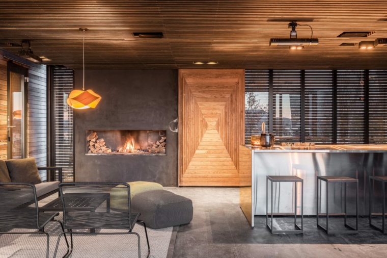 casas en noruega-isla-salon-cocina-chimenea-pared