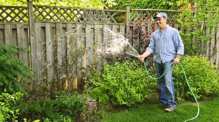 hombre regando jardin